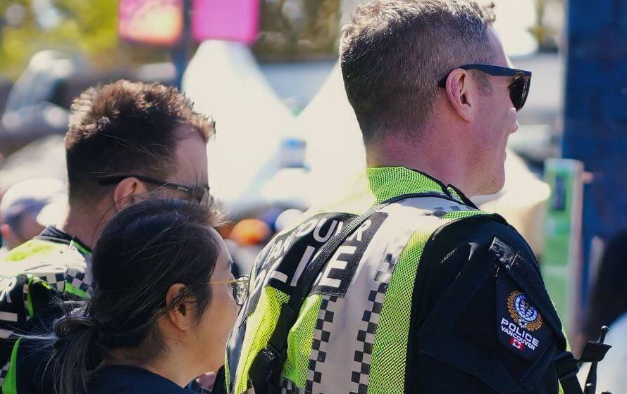 vpd police officers interacting with the public at a community event, representing a transition to RCMP policing