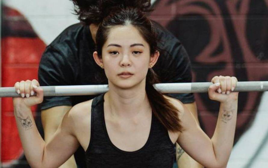 Female RCMP cadet performing barbell squat during fitness preparation training