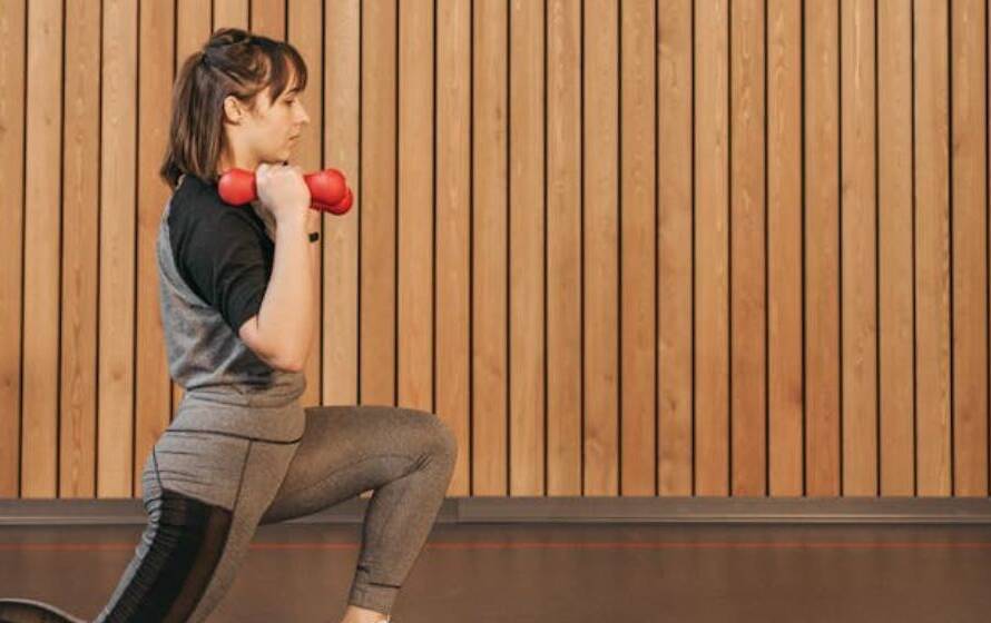 Female RCMP cadet performing weighted lunges during strength training workout
