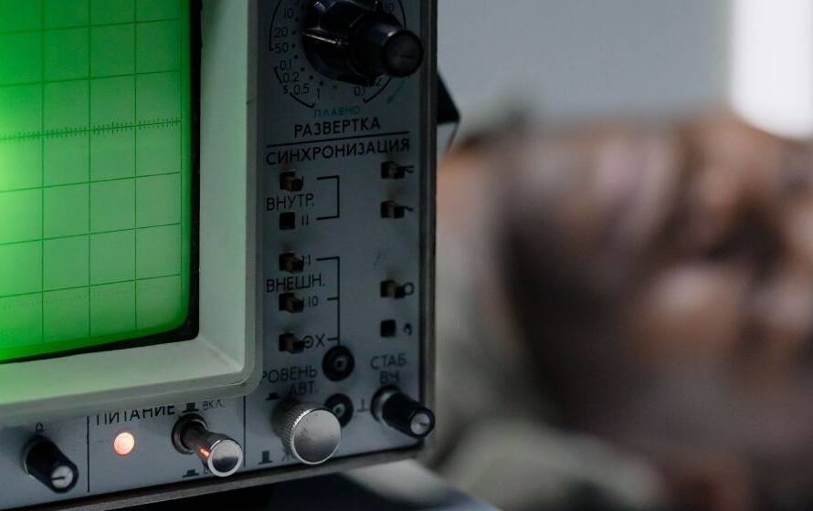 Polygraph examination equipment displaying physiological readings on a monitor while a candidate undergoes testing, representing the RCMP's background screening and integrity assessment process.
