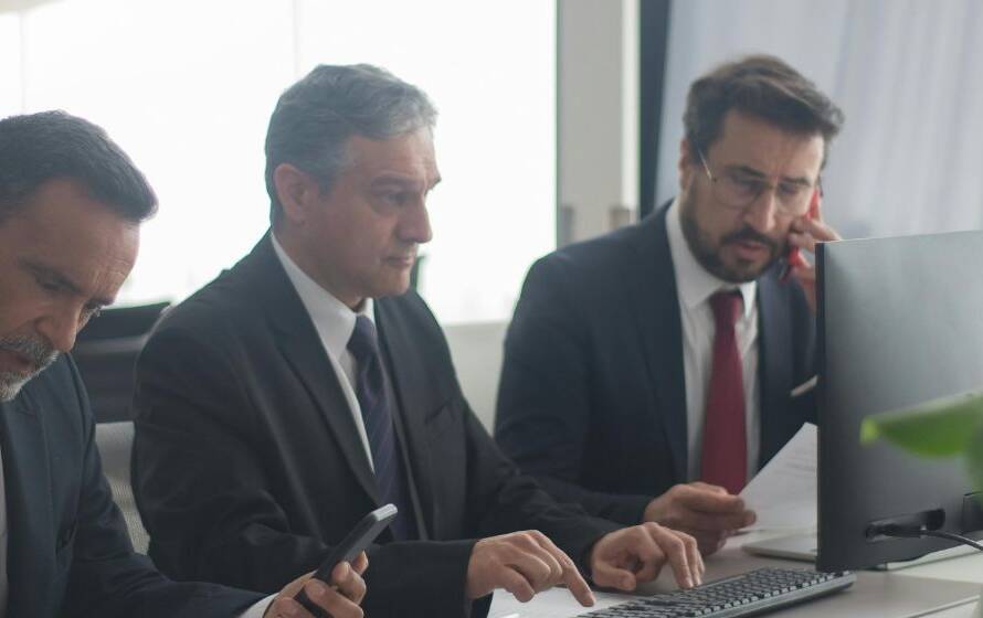 Professionals working in an office environment representing administrative responsibilities, teamwork, and daily operational routines during RCMP training and policing careers.